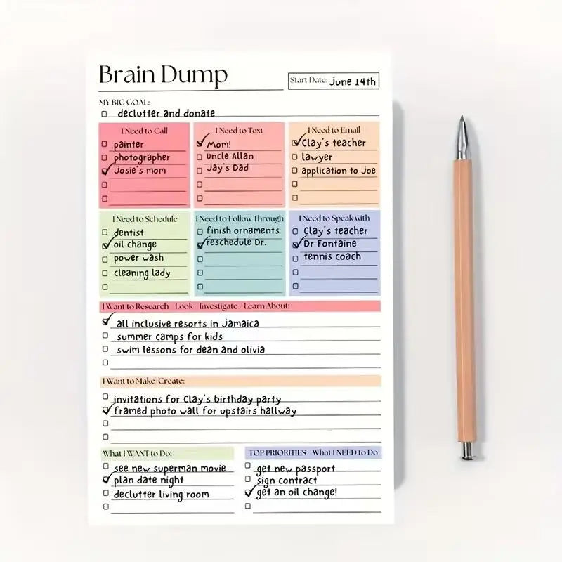 A lined notepad page titled 'Brain Dump' with colored task categories and checkboxes, shown on a white background with a wooden and silver pen beside it.